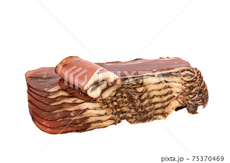 Sliced prosciutto strips isolated on white background. Sliced prosciutto strips isolated on white background. 75370469