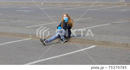 Portrait of sad caucasian child in face mask on closed playground outdoor. Coronavirus social distance quarantine. Portrait of sad caucasian child in face mask on closed playground outdoor. Coronavirus social distance quarantine. 75370785