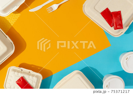 Lunchboxes and cutlery on colorful table. Flat lay top view food delivery concept 75371217