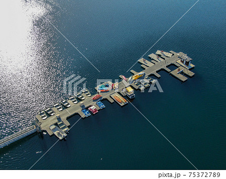 Aerial view of Miramar Lake small pier with pedal boat, small motor boat. 75372789