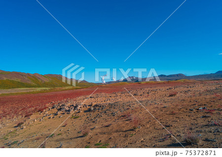Colorful geothermal active zone Hverir near Myvatn lake in Iceland, resembling Martian red planet landscape, at summer and blue sky. 75372871