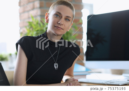 Closeup woman leader on brick wall background 75375193