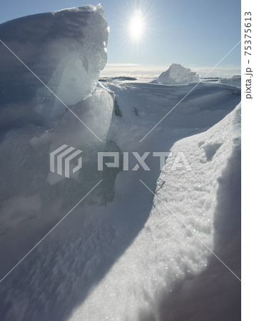Ice slopes in sunny winter day, transparent ice of blue color, purely blue sky, long shadows, a pure snow-covered virgin soil, snow barkhans, Ice slopes in sunny winter day, transparent ice of blue color, purely blue sky, long shadows, a pure snow-covered virgin soil, snow barkhans, 75375613