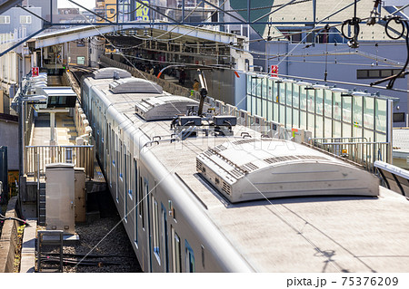 都市の駅に進入する通勤電車 都市の駅に進入する通勤電車 75376209