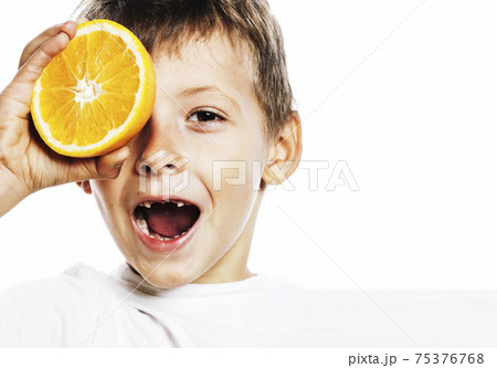 little cute boy with orange fruit double isolated on white smiling without front teeth adorable kid cheerful 75376768