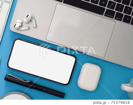 Creative flat lay workspace with smartphone, laptop, earphone and supplies on light blue background Creative flat lay workspace with smartphone, laptop, earphone and supplies on light blue background 75379818