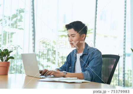 Asian businessman typing laptop keyboard 75379983