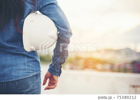 Woman engineer entrepreneur construction industry worker. Female engineer working refinery oil plant manufacturing. Young civil engineering construction wear hard hat safety helmet construction site. 75380212