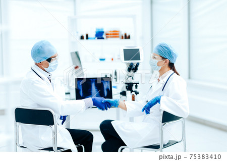 close up. medical colleagues shaking hands with each other . close up. medical colleagues shaking hands with each other . 75383410