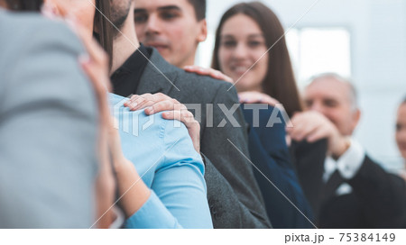 close up. a group of young professionals supporting each other. 75384149