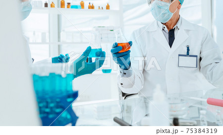 scientists and doctors work in a modern laboratory. 75384319