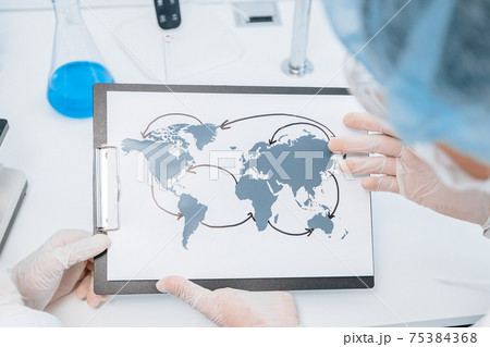 close up. map of the spread of coronavirus in the hands of an epidemiologist. Elements of this image furnished by NASA 75384368