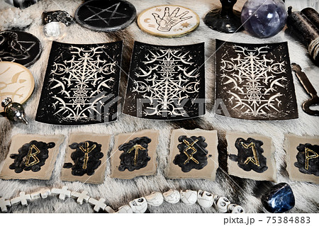 Still life with tarot cards and runes, magic ritual objects and crystals on witch table.  Esoteric, gothic and occult background, Halloween mystic concept. 75384883