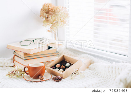 Cup coffee drink box various chocolates ceramic dish. Morning tea by the window Cup coffee drink box various chocolates ceramic dish. Morning tea by the window 75385463