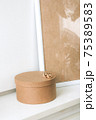 Blank beige poster frame, craft round box on the white wall 75389583