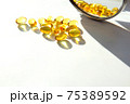 Fish oil capsules on a light background 75389592