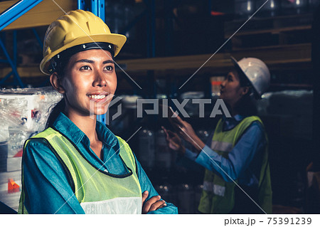 Portrait of young woman warehouse worker smiling in the storehouse 75391239
