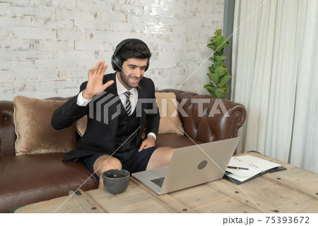 Portrait of smiling business, middle east CEO man working from home and talking to colleagues in webcam group video call conference on internet online on laptop computer notebook device in quarantine. Portrait of smiling business, middle east CEO man working from home and talking to colleagues in webcam group video call conference on internet online on laptop computer notebook device in quarantine. 75393672