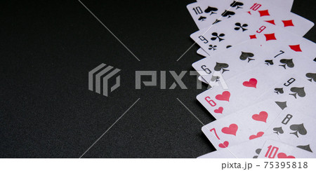 Playing cards on black background with copy space. Stay home leisure activity for family and friends. Poker Playing cards on black background with copy space. Stay home leisure activity for family and friends. Poker 75395818