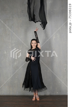 Woman dancer in motion with a cloth against the wall Woman dancer in motion with a cloth against the wall 75396319