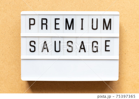 Lightbox with word premium sausage on wood background 75397365