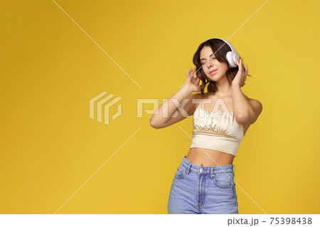 young woman with headphones listening to music 75398438