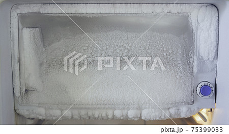 freezer of a refrigerator. Ice buildup inside of a freezer walls. 75399033