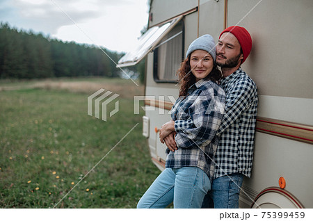 Romantic couple spending time together near trailer home. Romantic couple spending time together near trailer home. 75399459