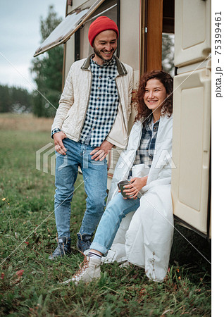 Romantic couple spending time together near trailer home Romantic couple spending time together near trailer home 75399461