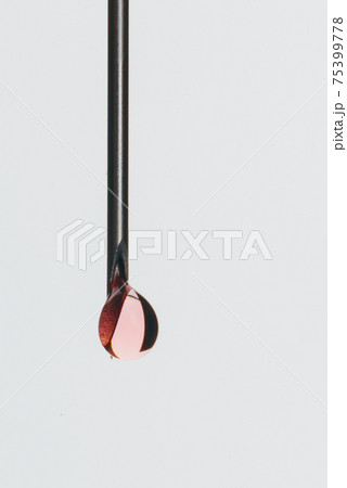 Medical Syringe needle isolated on white, macro shooting. Isolated needle filled with red medication liquid. Drop of liquid is red as blood. Medical Syringe needle isolated on white, macro shooting. Isolated needle filled with red medication liquid. Drop of liquid is red as blood. 75399778