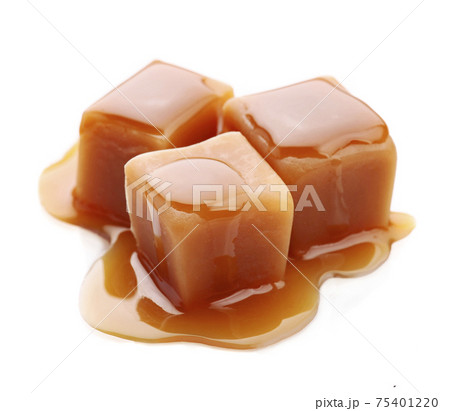 Caramel candy with caramel topping on white backgrounds 75401220