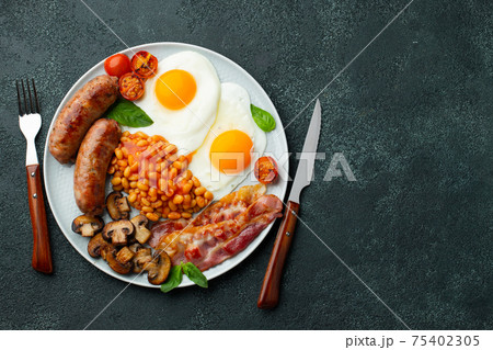 Full English breakfast on a plate with fried eggs Full English breakfast on a plate with fried eggs 75402305