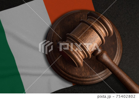 Judge gavel and flag of Ireland. Law and justice in Ireland. Violation of rights and freedoms Judge gavel and flag of Ireland. Law and justice in Ireland. Violation of rights and freedoms 75402802