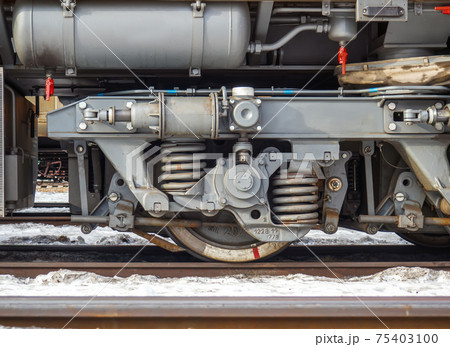 Railway bogie of small diesel maneuvering locomotive. Close-up. Railway bogie of small diesel maneuvering locomotive. Close-up. 75403100