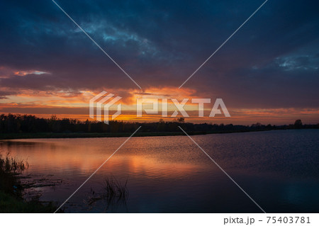 Colorful sky and clouds after sunset on the lake Colorful sky and clouds after sunset on the lake 75403781