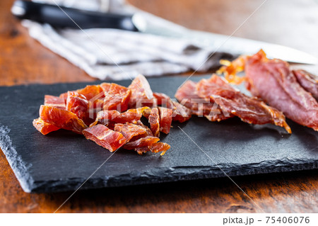 Dried chicken meat. Tasty jerky meat. Dried chicken meat. Tasty jerky meat. 75406076