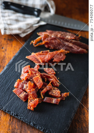 Dried chicken meat. Tasty jerky meat. Dried chicken meat. Tasty jerky meat. 75406077