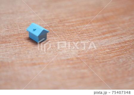 Minimal design one single miniature house with copy space. Blue toy home property market housing mortgage loan. Symbol of house on wood background. Real estate buy sell home icon property house model Minimal design one single miniature house with copy space. Blue toy home property market housing mortgage loan. Symbol of house on wood background. Real estate buy sell home icon property house model 75407348
