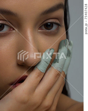 Skin Care Mask. Closeup Portrait Of Attractive Young Woman With Grey Clay Facial Mask On Healthy Fresh Fingers Skin. Beauty photo and nude make up. High resolution Skin Care Mask. Closeup Portrait Of Attractive Young Woman With Grey Clay Facial Mask On Healthy Fresh Fingers Skin. Beauty photo and nude make up. High resolution 75407428