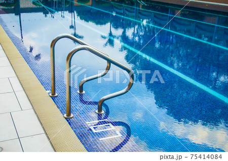 Swimming pool without people with metal handrails 75414084