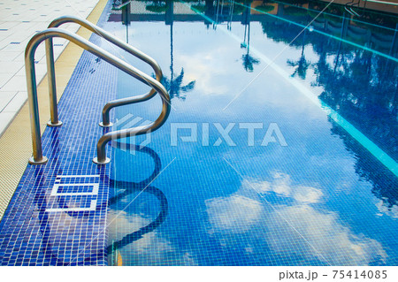 Swimming pool without people with metal handrails 75414085