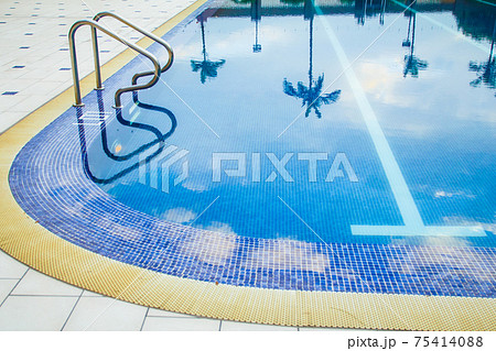 Swimming pool without people with metal handrails Swimming pool without people with metal handrails 75414088