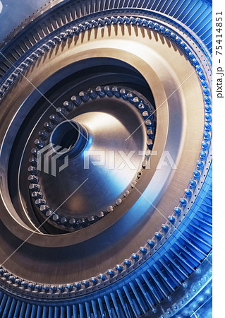 The rotor disk with the blades of a turbojet gas turbine engine with a blue glow. The rotor disk with the blades of a turbojet gas turbine engine with a blue glow. 75414851