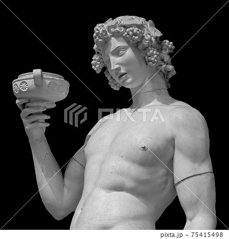 Ancient statue of Dionysus isolated on a black background. Dionysus is the God of the grape harvest, wine and merriment. Also known as Bacchus 75415498