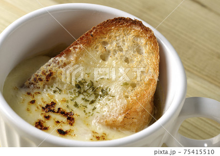チーズに焦げ目のついてるフランスパンが入ったオニオンスープ 75415510