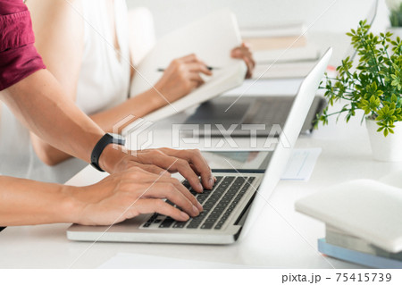 Young woman and man studying for a test or exam Tutor books with friends catching up and learning, education and school concept. 75415739