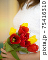 Soft focus of anonymous female carrying bunch of colorful fresh tulips during holiday celebration in spring 75416310