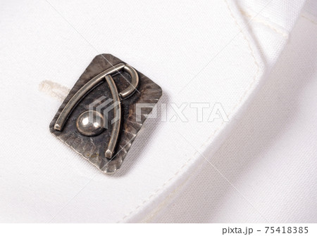 Cufflink on a white shirt 75418385