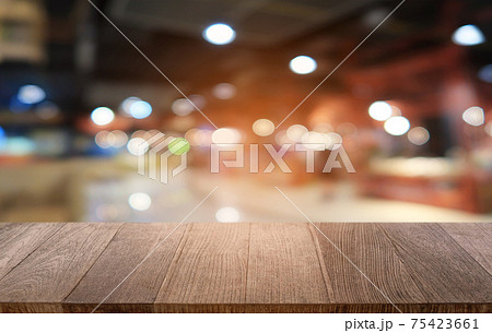 Empty dark wooden table in front of abstract blurred bokeh background of restaurant . can be used for display or montage your products.Mock up for space. Empty dark wooden table in front of abstract blurred bokeh background of restaurant . can be used for display or montage your products.Mock up for space. 75423661