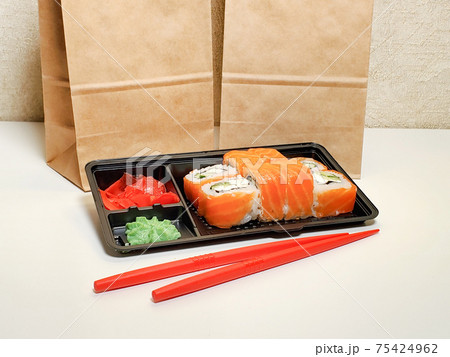 takeaway Lunch, delivery of sushi menu in lunch boxes. The concept of delivery takeaway Lunch, delivery of sushi menu in lunch boxes. The concept of delivery 75424962